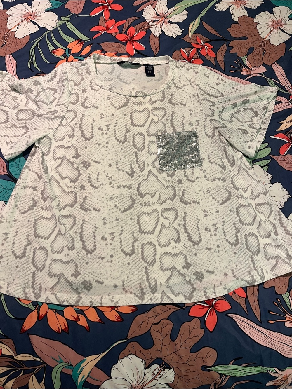 Animal print swing style tee with sequin pocket
